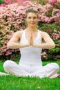 Blonde girl in park doing yoga Royalty Free Stock Photo