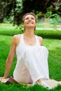 Blonde girl in park doing yoga Royalty Free Stock Photo