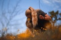 Blonde girl playing with puppy spanish mastiff in a field of yellow flowers Royalty Free Stock Photo