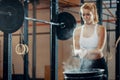 Blonde girl preparing to weightlifting at fitness center Royalty Free Stock Photo