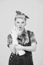 Blonde girl is ready to clean. pin up styled blonde girl take on hand gloves Royalty Free Stock Photo