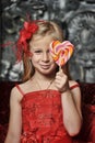 Girl in a red dress with candy in her hands Royalty Free Stock Photo