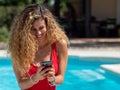 Blonde girl uses mobile phone inside the pool Royalty Free Stock Photo