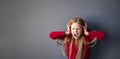 a blonde girl in a red T-shirt and headphones listens to music and shouts Royalty Free Stock Photo