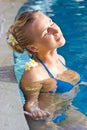 Blonde girl relaxing in hotel pool Royalty Free Stock Photo