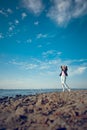 Blonde girl in black glasses and jeans posing on the beach Royalty Free Stock Photo