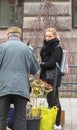 Blonde girl selling flower bouquets