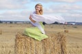 Blonde girl in sloping field Royalty Free Stock Photo