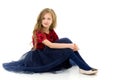 Blonde Girl in Stylish Tulle Dress Sitting on Floor Hugging her Knees Royalty Free Stock Photo