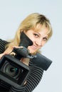 Blonde girl takes on professional video cameras. Royalty Free Stock Photo