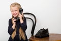 Blonde girl talking by old black phone Royalty Free Stock Photo