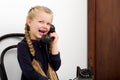 Blonde girl talking by old black phone Royalty Free Stock Photo