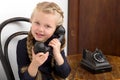 Blonde girl talking by old black phone Royalty Free Stock Photo