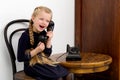 Blonde girl talking by old black phone Royalty Free Stock Photo