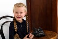 Blonde girl talking by old black phone Royalty Free Stock Photo