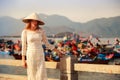 blonde girl in Vietnamese looks into camera at barrier