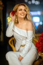 Blonde girl in white dress with a rose in her hand Royalty Free Stock Photo