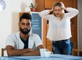 Blonde girl yelling at black boyfriend as quarreling indoors