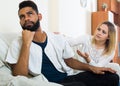 Blonde girl yelling at black boyfriend as quarreling indoors