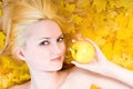 Blonde girl with yellow apple