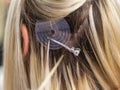 Blonde hair extensions procedure in beauty salon Royalty Free Stock Photo