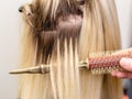 Blonde hair extensions procedure in beauty salon Royalty Free Stock Photo