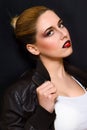 Blonde with hair gathered in a bun and professional make-up with dark red lips