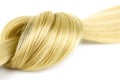 Blonde hair lock tied in knot. Strand of blond hair on white. Curls of hair. Blond wavy hair on white background