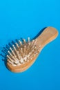 Blonde hair loss problem with hairbrush on blue background. Alopecia, hair problem, falling hair on brush healthy