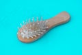 Blonde hair loss problem with hairbrush on blue background. Alopecia, hair problem, falling hair on brush healthy