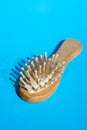 Blonde hair loss problem with hairbrush on blue background. Alopecia, hair problem, falling hair on brush healthy