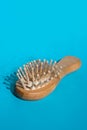 Blonde hair loss problem with hairbrush on blue background. Alopecia, hair problem, falling hair on brush healthy