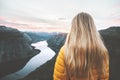 Blonde hair woman alone in sunset mountains adventure lifestyle