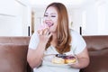 Blonde hair woman eats donut Royalty Free Stock Photo