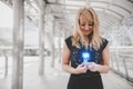 Blonde hair woman holding and looking at Blue light bulb with bright and shine line dot illustration effect. Future technology and