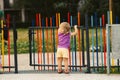 The blonde haired girl runs away from the playground Royalty Free Stock Photo