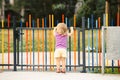 The blonde haired girl runs away from the playground Royalty Free Stock Photo