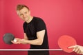 Blonde Haired Male playing table tennis