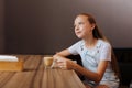 Blonde-haired teenager drinking decaf latte in cafe