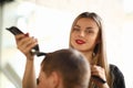 Blonde Hairstylist Cutting Man by Electric Shaver Royalty Free Stock Photo