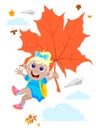 Blonde happy girl flying on a maple leaf by the beginning of the school year