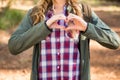 Blonde hiker framing heart with hands