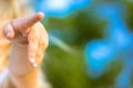 A blonde infant girl pointing finger into a distance straight. Baby girl& x27;s hand. Royalty Free Stock Photo