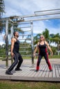 Blonde lady exercising with her personal trainer