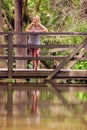 Blonde lady leaning over a bridge Royalty Free Stock Photo