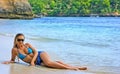 Blonde lady lying in water on the beach Royalty Free Stock Photo