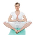 Blonde lady meditating in white