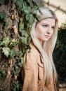 Blonde leaning on Tree