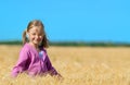 Blonde little girl on field of grain