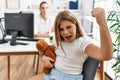 Blonde little girl at pediatrician clinic with female doctor annoyed and frustrated shouting with anger, yelling crazy with anger